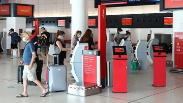 Passengers check in for their flight wearing face masks at Perth T3 Domestic Airport.