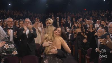 Billie Eilish hugs Margot Robbie before accepting her Oscar for 'What Was I Made For?'