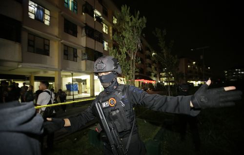 Heavily armed police have blocked off the streets around the site of church bombings in Surabaya, Indonesia. (AAP)