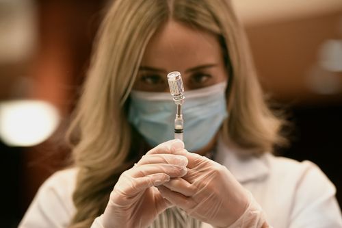 Pharmacist Madeline Acquilano draws a syringe of Johnson & Johnson COVID-19 at Hartford Hospital in Hartford, Connecticut.