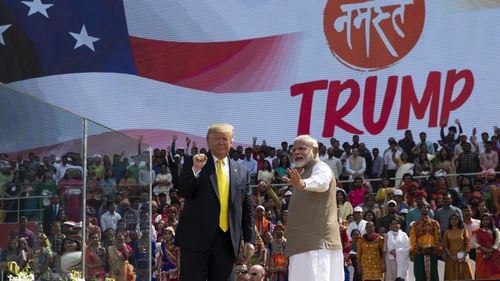 Mr Trump and Indian Prime Minister Narendra Modi wave after the "Namaste Trump" event.