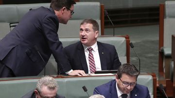 Minister David Littleproud approaches the backbench for a discussion with Nationals MP Llew O&#x27;Brien during Question Time at Parliament House, in 2019.