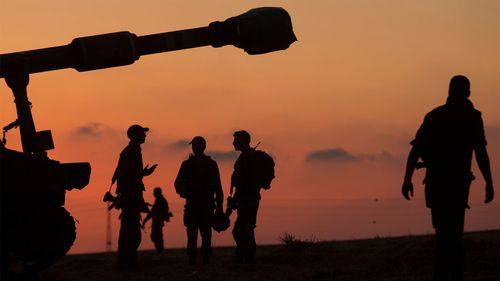 Israeli soldiers prepare their artillery unit near the border with Gaza Strip.