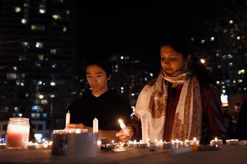 Mourners in Toronto light candles at a makeshift memorial for the victims mown down by the rental van. Picture: AP/The Canadian Press