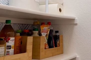 Paper towel storage in pantry made with tension rods.