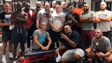 The players at Lyon College in Batesville, Arkansas, show off their shaved heads in the weight room.