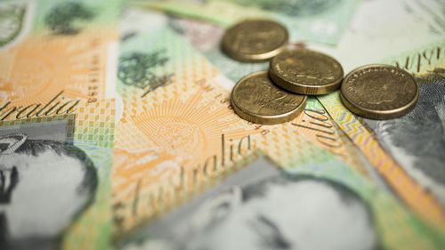 A generic picture of Australian money - $2 coins on top of $100 notes.