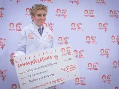 Origin Little Big Idea winner Josh Cowie posing with his winner's cheque.