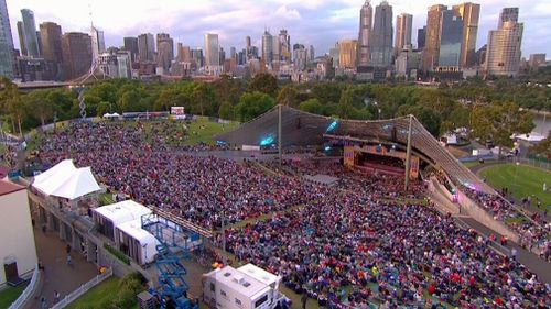 At least 10,000 are at the Sidney Myer Music bowl for Carols by Candlelight. (Channel 9)