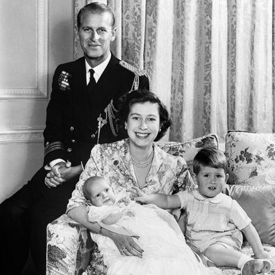 Queen Elizabeth poses for a family portrait with a young Charles and Anne