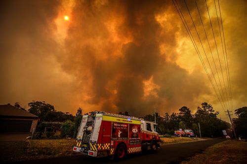 A bushfire approaches homes on the outskirts of the town of Bargo on December 21, 2019.