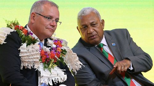 Fijian Prime Minister Frank Bainimarama and Scott Morriosn attend a traditional welcome ceremony.