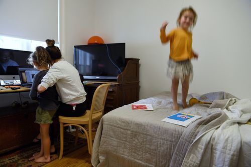 Jacky Ghossein works in her home office with her daughters at their home in Sydney. People all across Australia are staying at home to prevent contracting coronavirus.