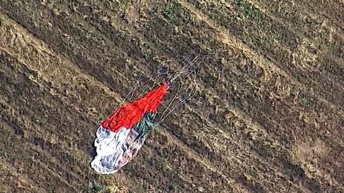 Screenshot taken from KABC-TV shows the parachute left by the pilot who ejected before his F-16 fighter jet crashed.