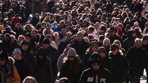 People walk during a memorial procession in Crans-Montana, Swiss Alps, Switzerland, Sunday, Jan. 4, 2026, after a devastating fire in Le Constellation bar left dead and injured during the New Year's celebrations. (AP Photo/ Antonio Calanni)