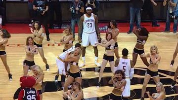 LeBron James (top) and his Cleveland Cavaliers are trapped by a squad of cheerleaders. (Getty Images)
