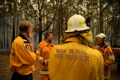 The NSW RFS Mogendoura unit discuss tomorrows plan whilst monitoring a fire at a property on Meadows Road at Mogendoura, ahead of tomorrows potentially catastrophic fire conditions. Mogendoura NSW. 3rd January, 2020. Photo: Kate Geraghty/SMH