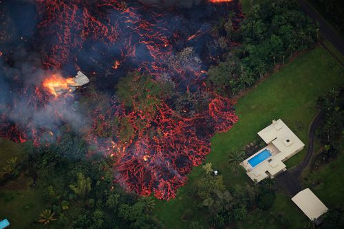 Lava from a robust fissure eruption on Kilauea's east rift zone consumes a home, then threatens another, near Pahoa. (AP)
