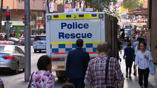 Police and paramedics swarmed to Sydney Tower after the woman died on the corner of Castlereagh and Market Streets. (9NEWS)