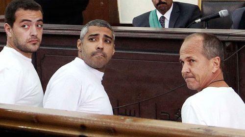 Al-Jazeera English producer Baher Mohamed, left, Canadian-Egyptian acting Cairo bureau chief Mohammed Fahmy, center, and correspondent Peter Greste, right, appear in court along with several other defendants during their trial on terror charges, in Cairo (AP Photo/Heba Elkholy, El Shorouk, File) 