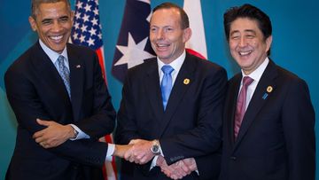 US President Barack Obama, Australian Prime Minister Tony Abbott, and Japan's Prime Minister Shinzo Abe shake hands during the G20 trilateral meeting. (Getty)