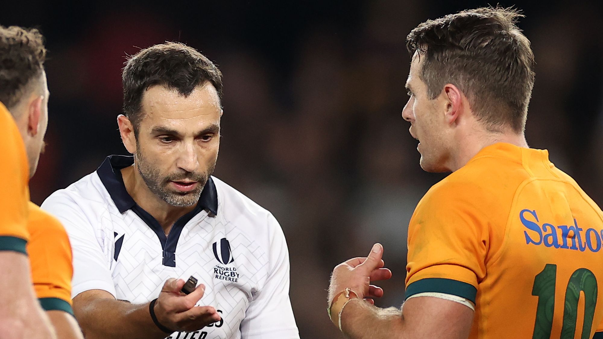 Referee Mathieu Raynal speaks to the Wallabies.