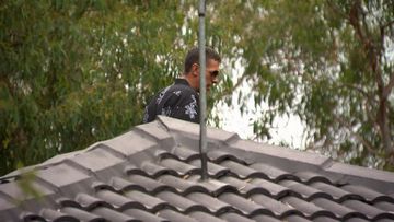The 33-year-old accused thief climbed onto a roof of a family's home.
