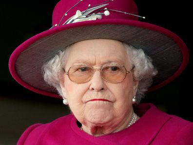 Queen Elizabeth II frowning, looking grumpy at Newbury Racecourse on April 17, 2015.