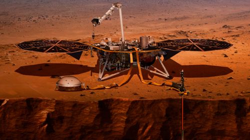 This NASA artist impression shows the InSight lander drilling into the surface of Mars.