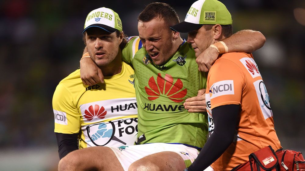 Trainers carry off Josh Hodgson (AAP)
