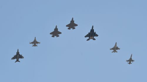 Two US F-35A fighter jets, centre and centre left, fly with South Korean air force fighter jets over Cheongju Air Base in Cheongju, South Korea in 2019.