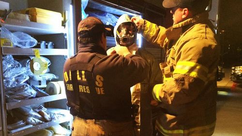 Dallas Fire Department workers suit up before entering the home of the second Texas nurse who tested positive for Ebola.