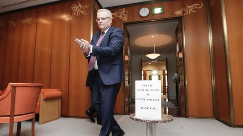 Scott Morrison sanitises his hands.