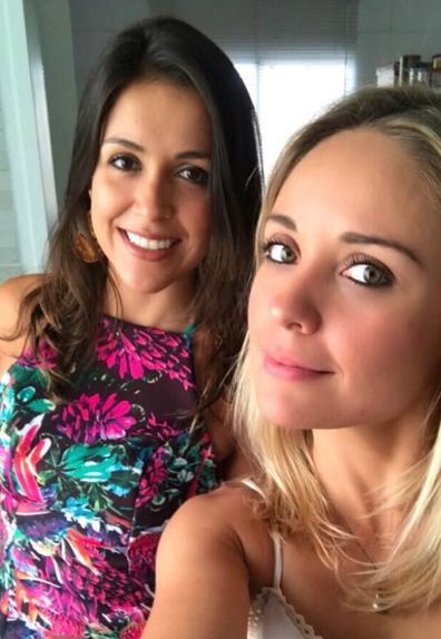 Brazilian fitness influencer Mara Flavia, right, with her sister. Flavia drowned during an Ironman triathlon event on April 18, 2026.