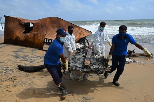 Members of Sri Lankan Navy remove debris washed ashore from the Singapore-registered container ship MV X-Press Pearl. 