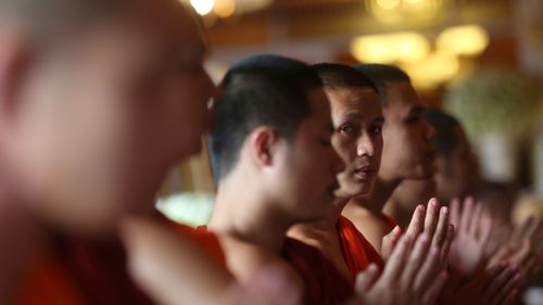 Thai Buddhist monks pray for members of the rescued soccer team and their coach during a Buddhist ceremony. (Image: AP)