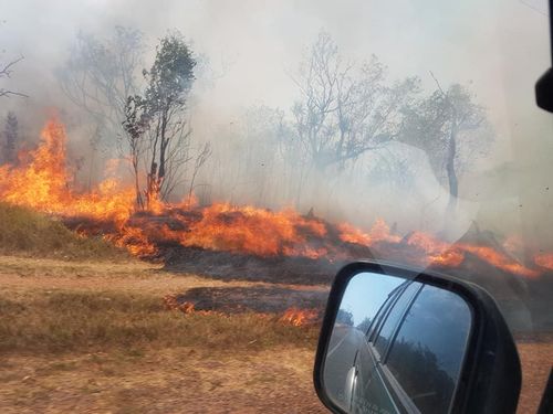 Fire crews are rushing to extinguish a large bushfire that is burning in a rural area near Darwin.