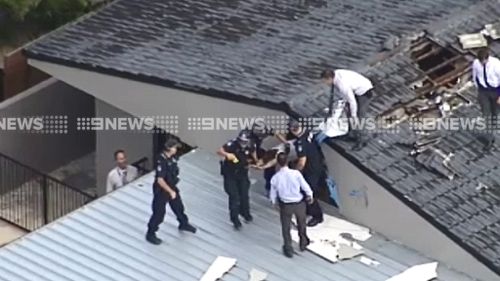 Police have arrested a man hiding in a roof in relation to the stabbing death of a Gold Coast teenager. (9NEWS)