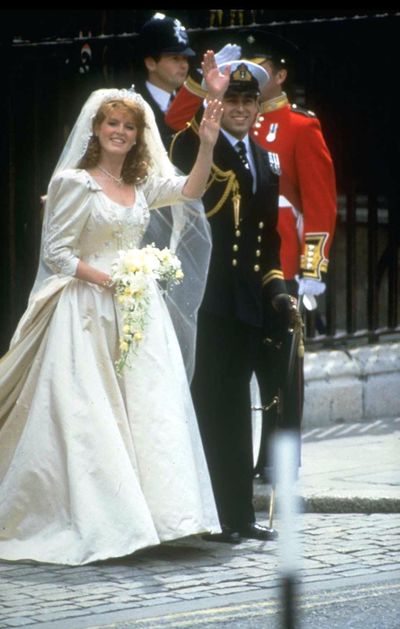 Prince Andrew, the Duke of York, and Sarah Ferguson wave outside of Buckingham Palace on their wedding day, London, England, July 23, 1986.