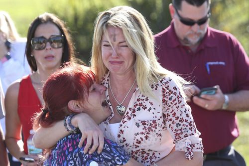 Parents wait near Stoneman Douglas High School. (AAP)