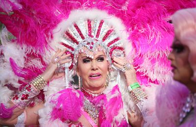 A drag queen adjusts her brilliant pink headdress. (AAP)
