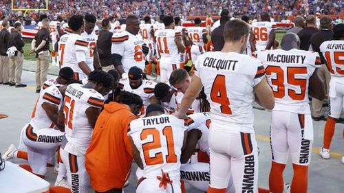 Cleveland Browns players kneel in protest during the national anthem.