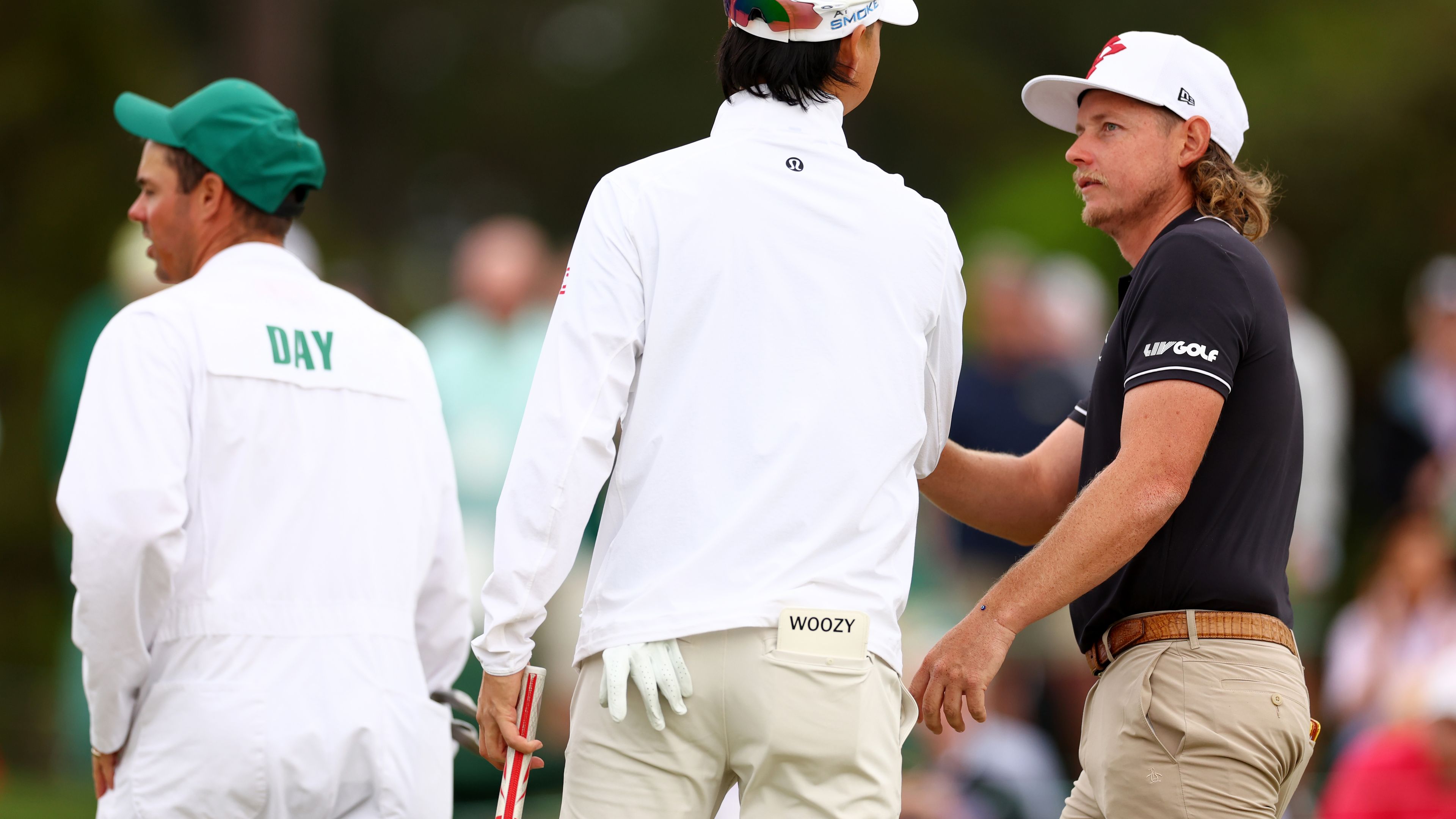 Min Woo Lee and Cameron Smith of Australia speak during a practice round prior to the 2024 Masters Tournament.