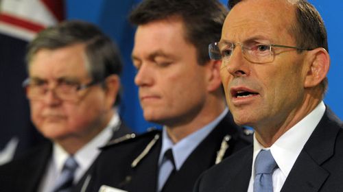 Prime Minister Tony Abbott (R) stands alongside Australian Federal Police Deputy Commissioner Andrew Colvin and and ASIO Chief David Irvine (L) during a press conference at the Federal Government offices in Melbourne. (AAP)
