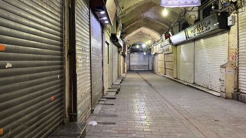 A protester flashes victory signs as traffic slows during demonstrations in Hamedan.