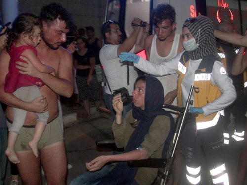 Turkish paramedics help people rescued from a boat that capsized off Cyprus' northern coastline. Picture: AP