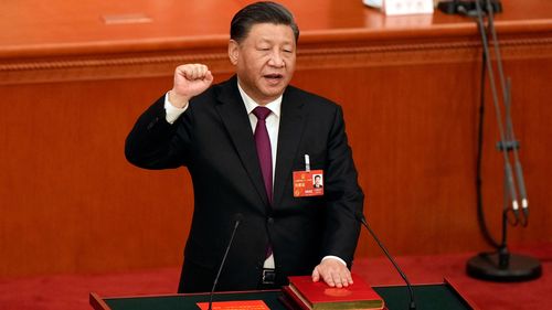 Chinese President Xi Jinping takes his oath after he is unanimously elected as President during a session of China's National People's Congress