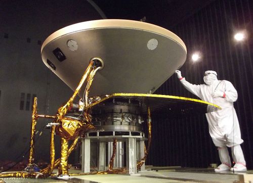 This file photo shows a NASA technician preparing the InSight spacecraft for thermal vacuum testing.