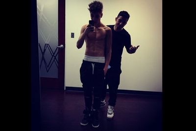 Bieber shows off his pecks again. This time, with help from a friend.