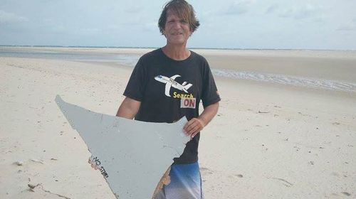 Blaine Gibson holding a piece of what appears to be MH370 debris. 